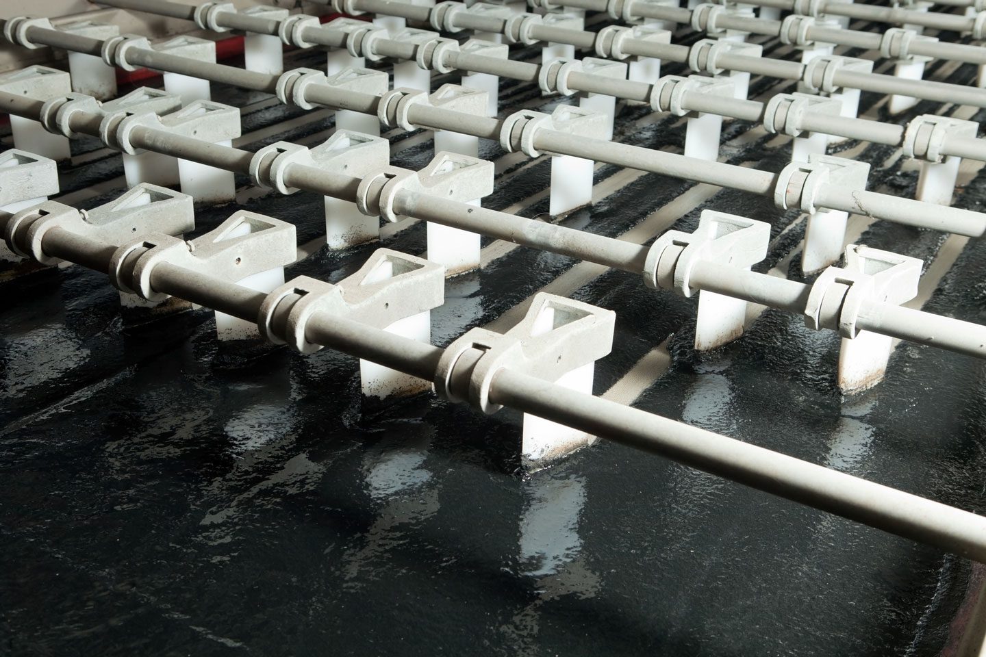 Wet industrial parts on conveyor system requiring air blow-off moisture removal before next production stage